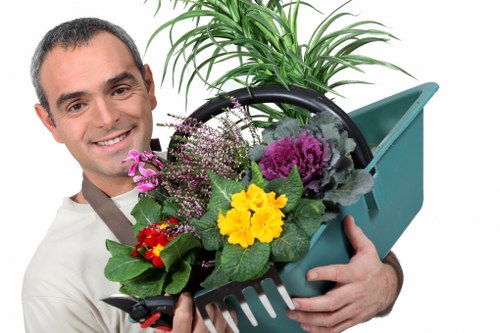 Professional gardener shaping shrubs in Childs Hill garden